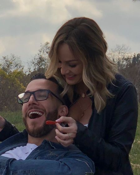 Clare Crawley in a black feeding  her ex-lover Benoit Beausejour-Savard.